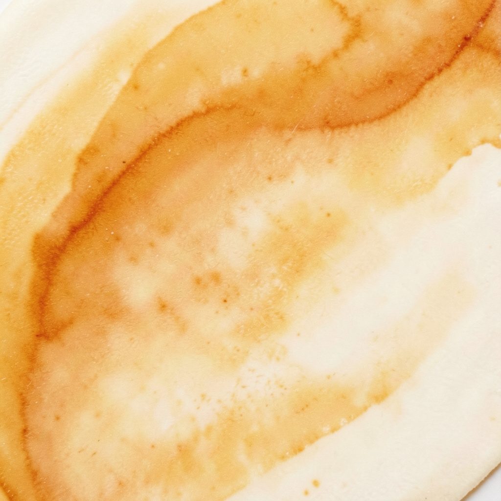 Warm amber and cream abstract texture suggesting natural skincare ingredients